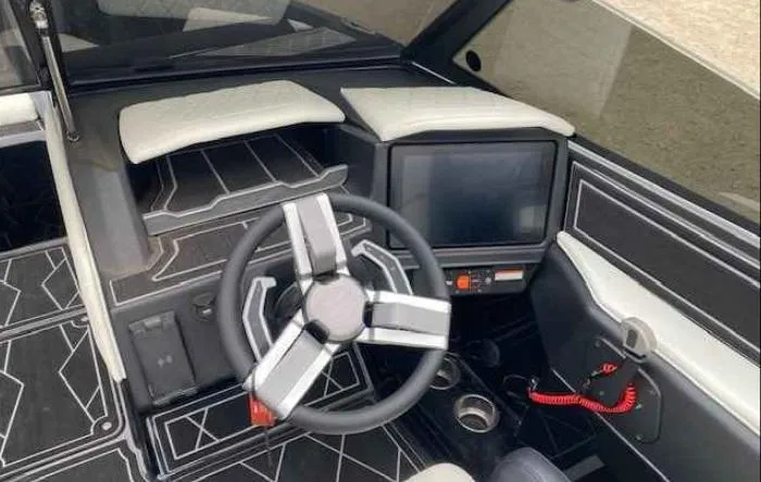 Slide: The Image of 2024 Tigé Z5 boat interior with modern steering wheel and touchscreen display. - 6