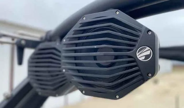 Slide: The Image of 2024 Tigé Z5 boat speakers, black grille design, mounted on a wakeboard tower. - 9