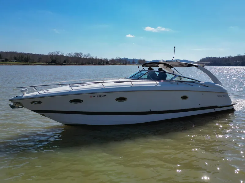 Slide: The Image of 2004 Cobalt 360 boat cruising on a sunny lake. - 11