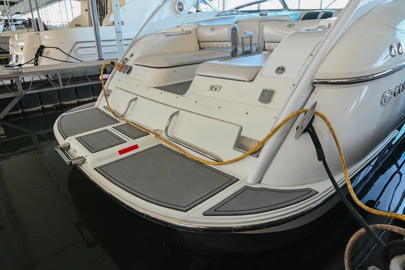 Slide: The Image of 2004 Cobalt 360 boat docked, featuring spacious seating and sleek design. - 18