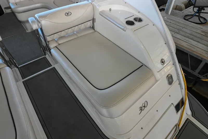 Slide: The Image of 2004 Cobalt 360 boat interior with cushioned seating and cup holders. - 22