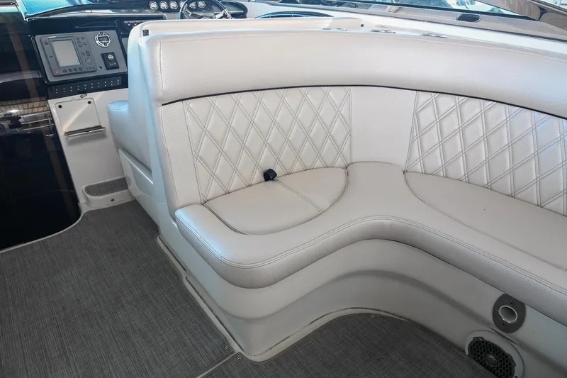 Slide: The Image of 2004 Cobalt 360 boat interior with white leather seating and diamond stitching. - 39