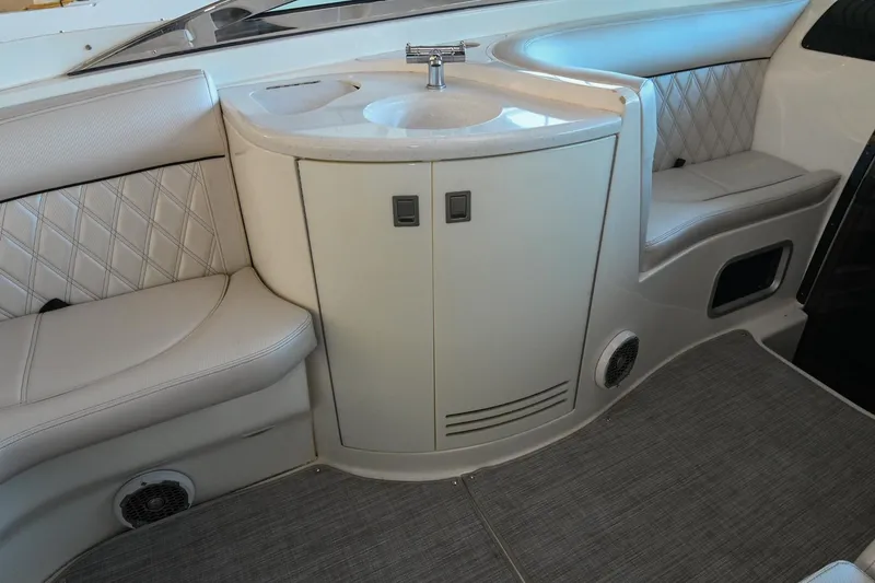 Slide: The Image of Interior of 2004 Cobalt 360 boat with sink and cushioned seating. - 40