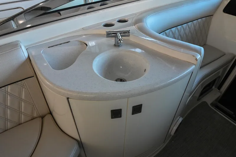 Slide: The Image of 2004 Cobalt 360 boat interior with sink and seating area. - 42