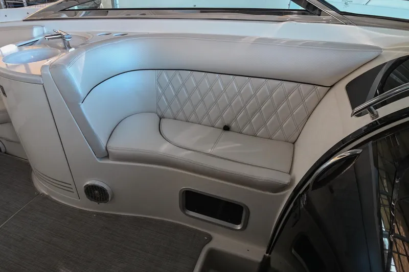 Slide: The Image of 2004 Cobalt 360 boat interior with white leather seating and built-in speaker. - 45