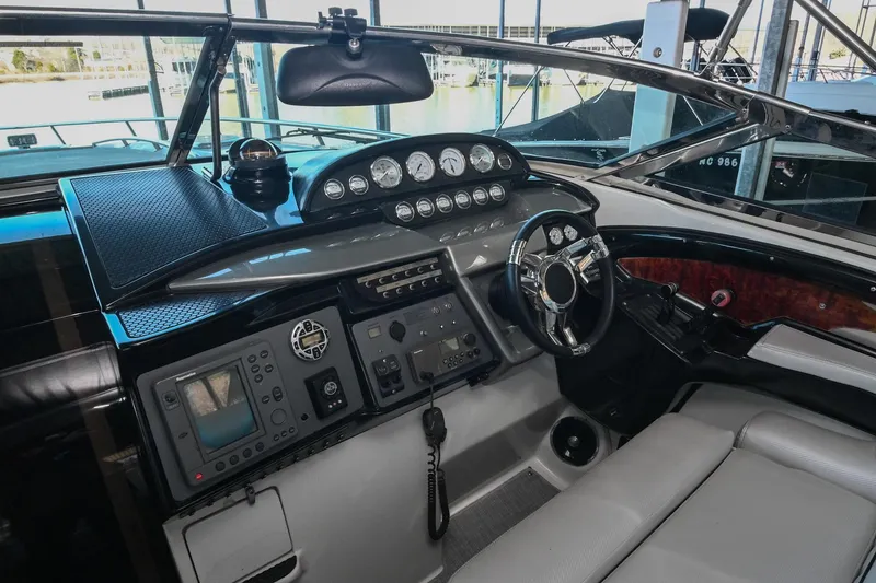 Slide: The Image of 2004 Cobalt 360 boat dashboard with steering wheel and navigation instruments. - 47