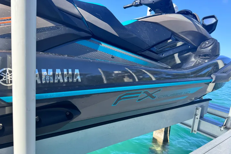 Slide: The Image of 2023 Yamaha WaveRunner FX Cruiser H/O on dock, sleek design, vibrant blue accents. - 3