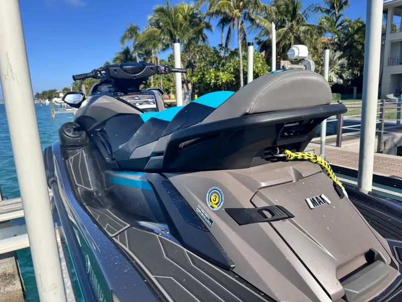 Slide: The Image of 2023 Yamaha WaveRunner FX Cruiser H/O docked by tropical waterfront. - 4
