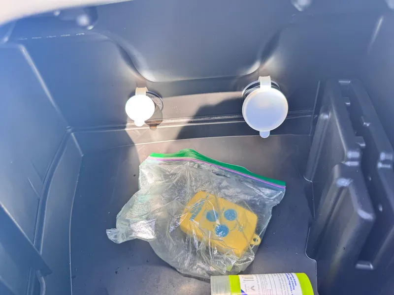 Slide: The Image of Storage compartment of 2023 Yamaha WaveRunner FX Cruiser H/O with items inside. - 7