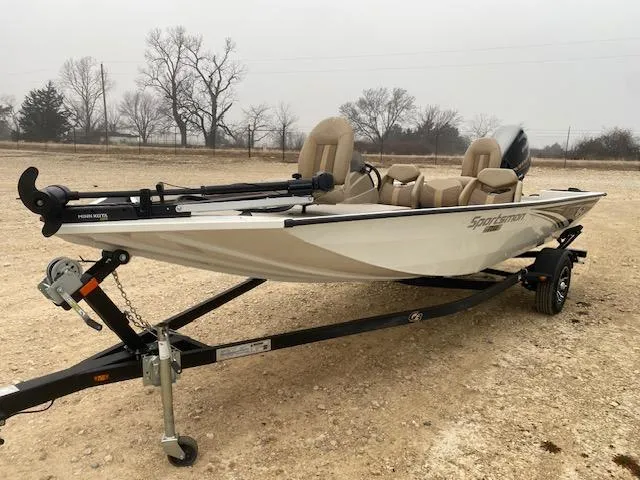 Slide: The Image of 2024 G3 Sportsman 1710 boat on trailer, beige seats, outdoor setting. - 2