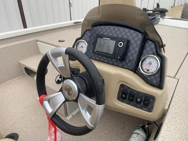 Slide: The Image of 2024 G3 Sportsman 1710 boat dashboard with steering wheel and gauges. - 6