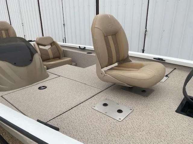 Slide: The Image of 2024 G3 Sportsman 1710 boat interior with beige seating and carpeted deck. - 8
