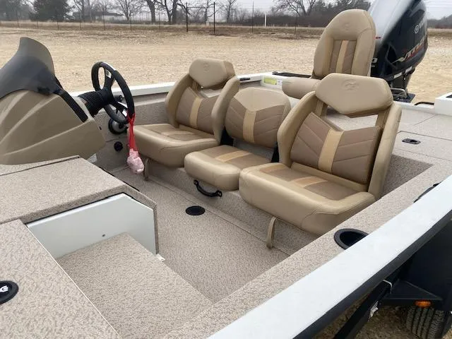 Slide: The Image of 2024 G3 Sportsman 1710 boat interior with beige seating and steering console. - 9