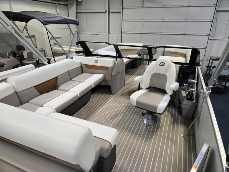 Slide: The Image of 2025 Princecraft Vectra 23 WRL pontoon boat interior with plush seating and modern helm. - 12