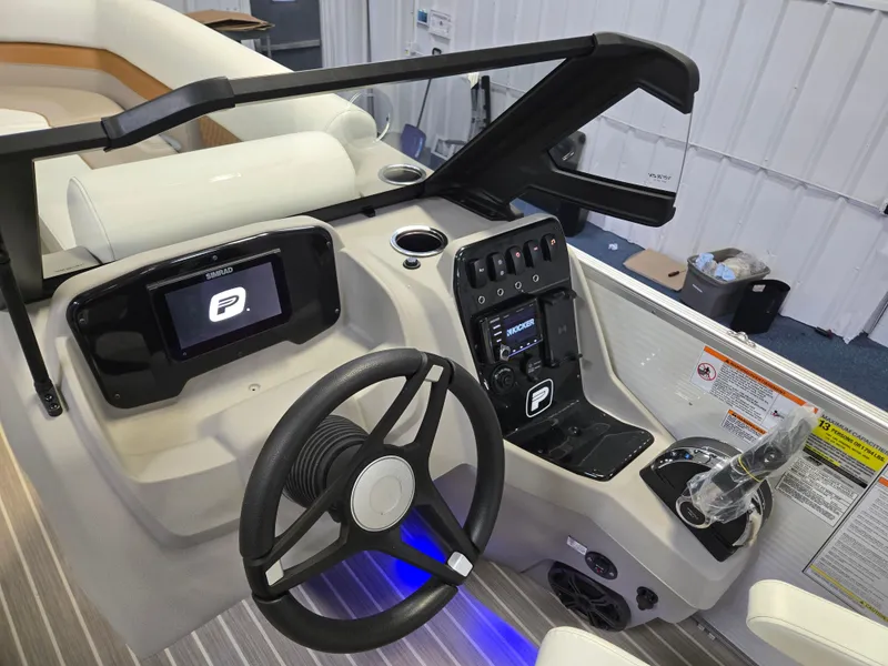 Slide: The Image of Interior view of 2025 Princecraft Vectra 23 WRL boat dashboard with steering wheel and controls. - 19