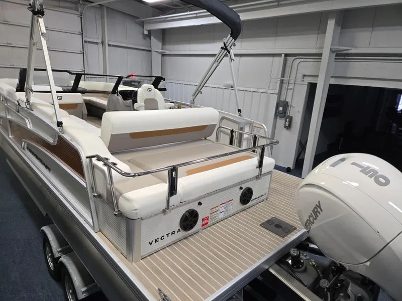 Slide: The Image of 2025 Princecraft Vectra 23 WRL pontoon boat with Mercury outboard motor in a showroom. - 6
