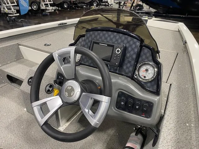 Slide: The Image of 2024 G3 Sportsman 1710 boat dashboard with steering wheel and control panel. - 4