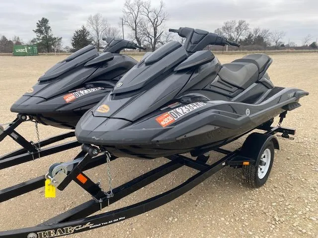 Slide: The Image of 2020 Yamaha WaveRunner FX Cruiser SVHO jet skis on a trailer, parked outdoors. - 2