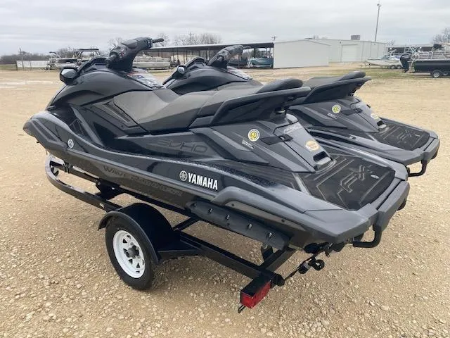 Slide: The Image of 2020 Yamaha WaveRunner FX Cruiser SVHO jet skis on a trailer, parked outdoors. - 3