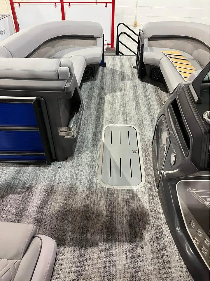 Slide: The Image of 2025 Bennington M 24 Fastback SE interior with gray seating and modern dashboard. - 10