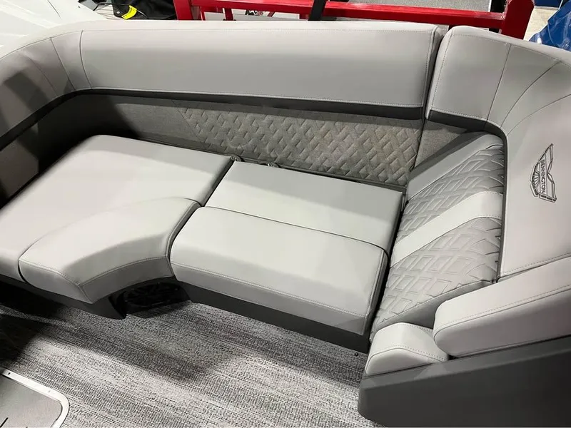 Slide: The Image of 2025 Bennington M 24 Fastback SE interior with luxurious gray seating and quilted accents. - 11