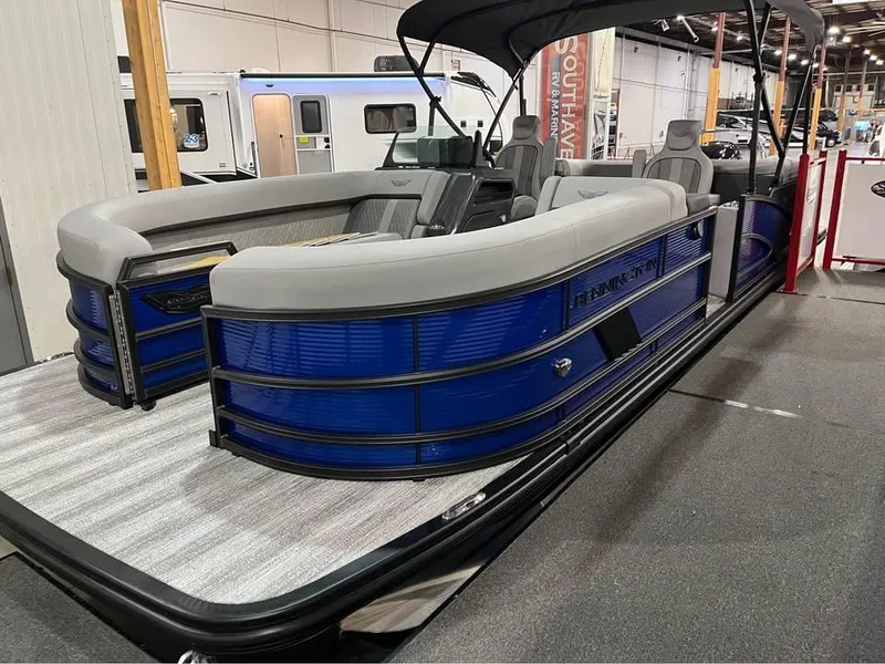 Slide: The Image of 2025 Bennington M 24 Fastback SE pontoon boat with sleek blue design on display. - 5