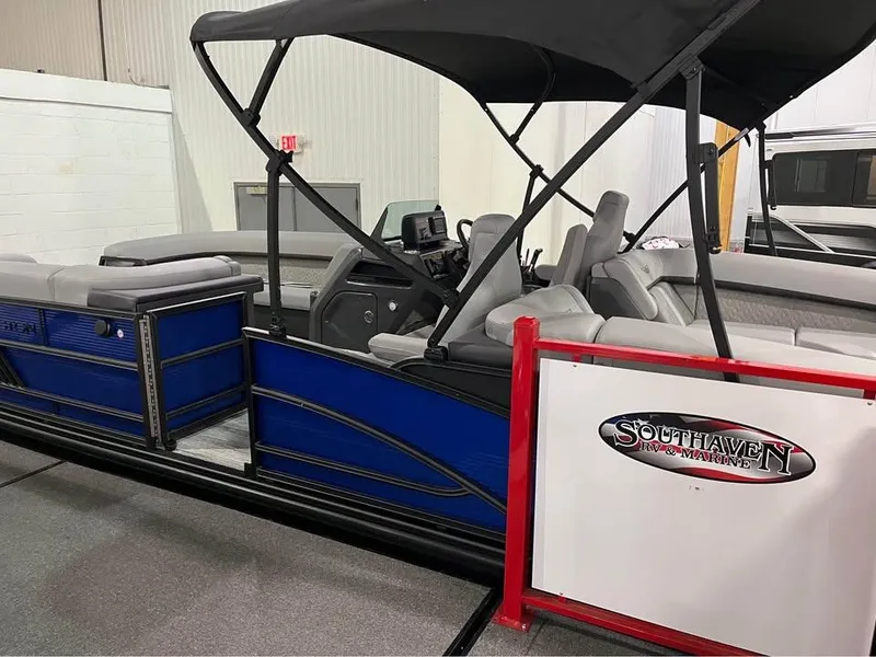 Slide: The Image of 2025 Bennington M 24 Fastback SE pontoon boat with canopy at Southaven showroom. - 7