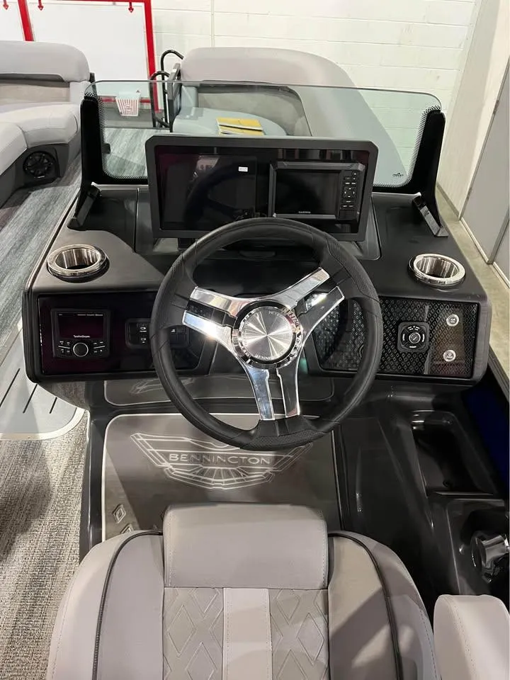 Slide: The Image of 2025 Bennington M 24 Fastback SE boat dashboard with modern steering and controls. - 8