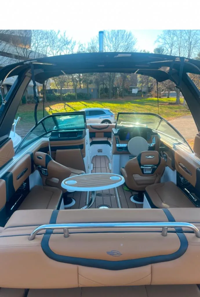 Slide: The Image of Interior view of a 2021 Chaparral 267 SSX boat with luxurious seating and modern dashboard. - 10
