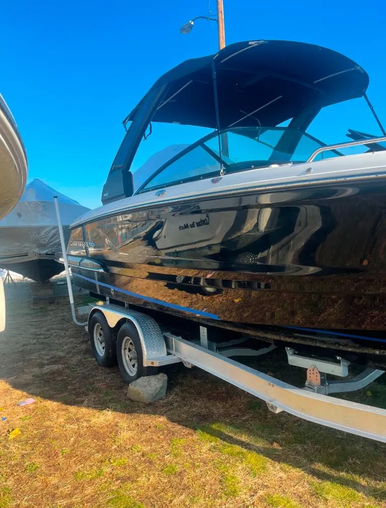 Slide: The Image of 2021 Chaparral 267 SSX boat on trailer, black exterior, sunny day. - 11