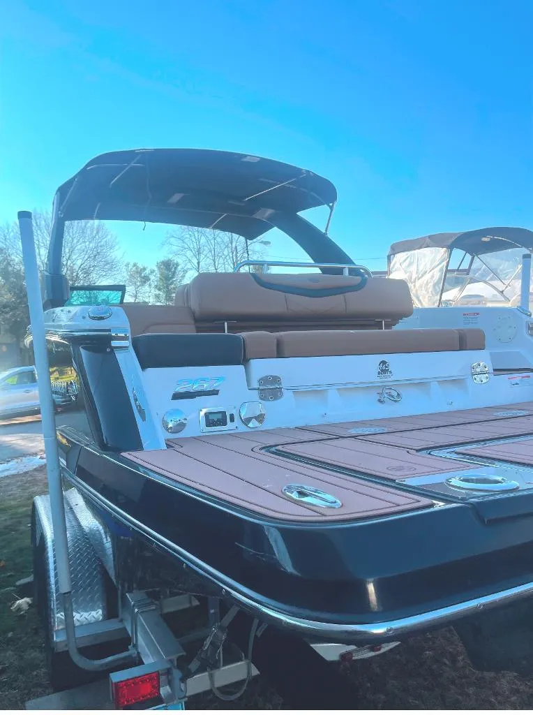 Slide: The Image of 2021 Chaparral 267 SSX boat with sleek design and spacious deck. - 12