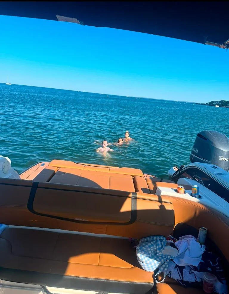 Slide: The Image of 2021 Chaparral 267 SSX boat with swimmers in a sunny ocean setting. - 4