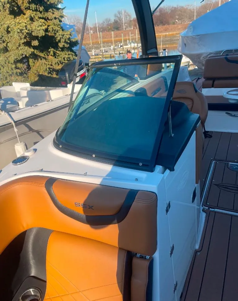 Slide: The Image of 2021 Chaparral 267 SSX boat with tan seating and sleek design. - 6