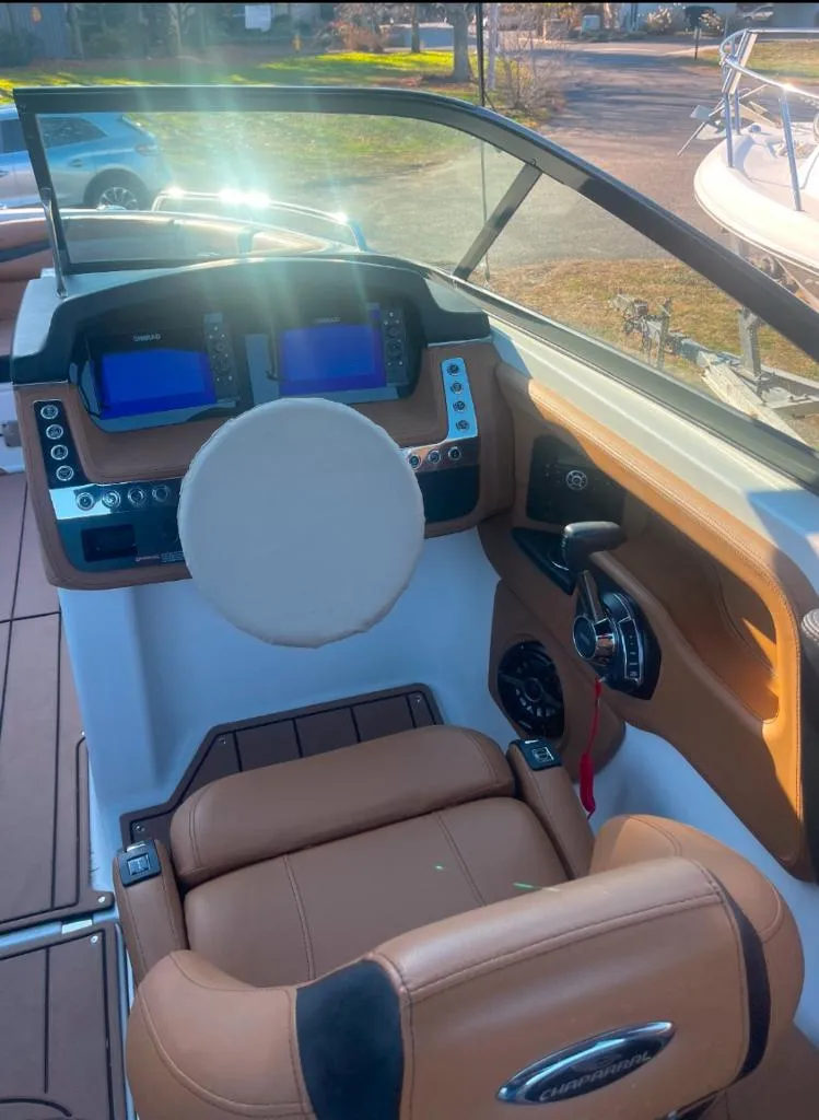 Slide: The Image of 2021 Chaparral 267 SSX boat cockpit with modern controls and tan seating. - 9