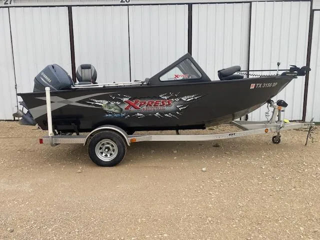 Slide: The Image of 2009 Xpress DVX175 boat on trailer, parked outdoors. - 0