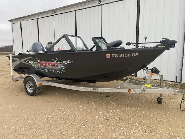 Slide: The Image of 2009 Xpress DVX175 boat on trailer, parked outside storage units. - 1