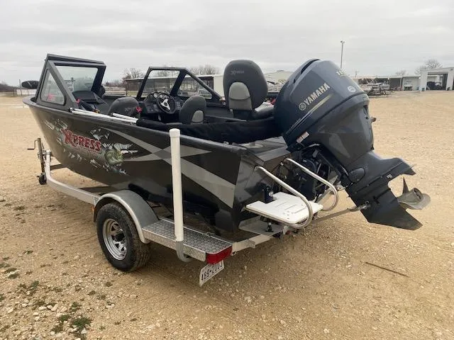 Slide: The Image of 2009 Xpress DVX175 boat with Yamaha outboard motor on a trailer, parked outdoors. - 3