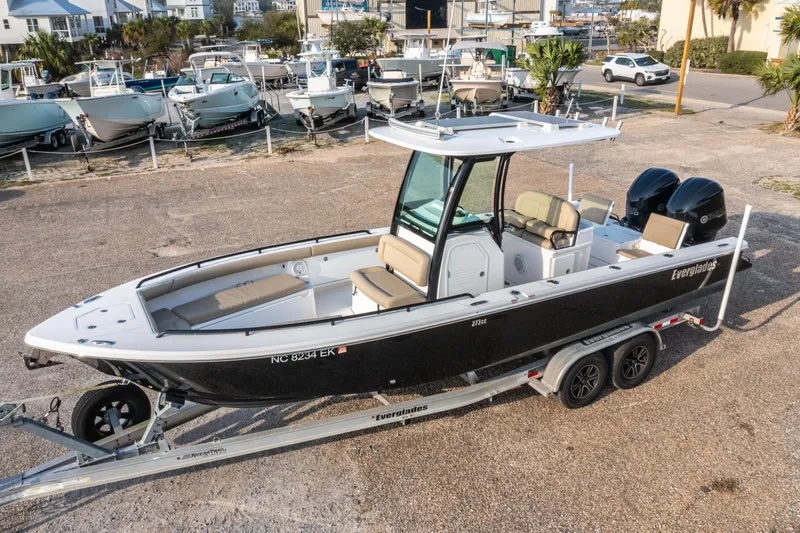 Slide: The Image of 2019 Everglades 273CC boat on trailer, parked in marina lot. - 2