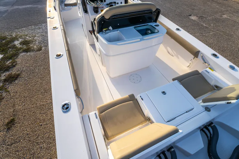 Slide: The Image of 2019 Everglades 273CC boat interior with beige seating and spacious deck. - 21