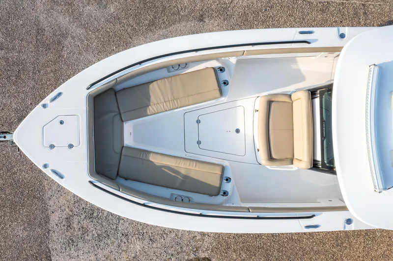 Slide: The Image of 2019 Everglades 273CC boat interior with beige seating and spacious deck. - 23
