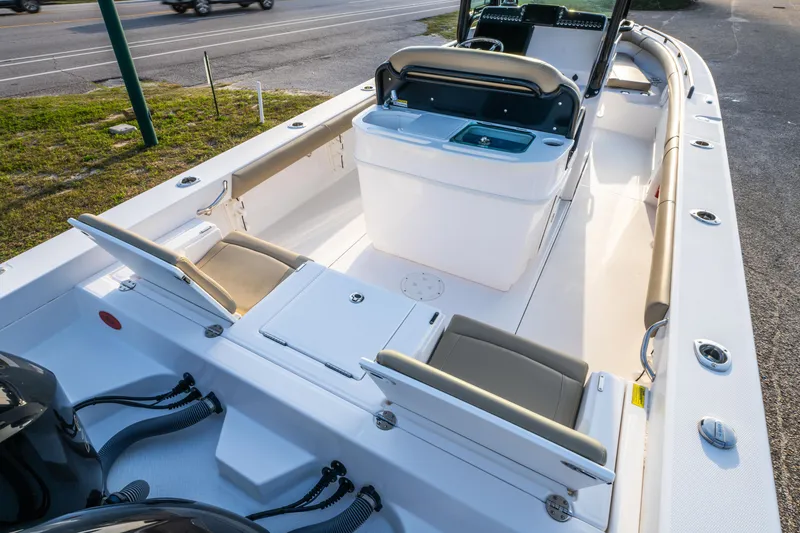Slide: The Image of 2019 Everglades 273CC boat interior with beige seating and dual engines. - 28