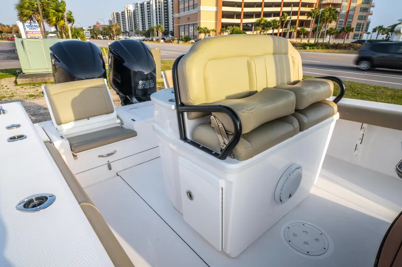 Slide: The Image of 2019 Everglades 273CC boat cockpit with steering wheel, control panel, and cup holders. - 30