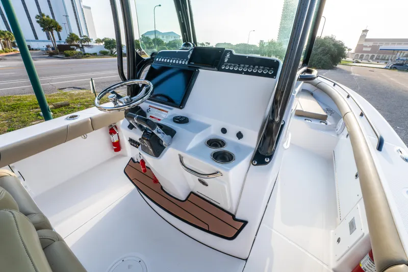 Slide: The Image of 2019 Everglades 273CC boat interior with beige seating and sleek design. - 33