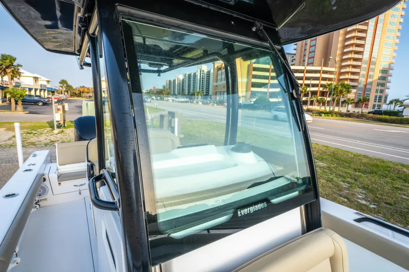 Slide: The Image of 2019 Everglades 273CC boat dashboard with steering wheel and control panel. - 39