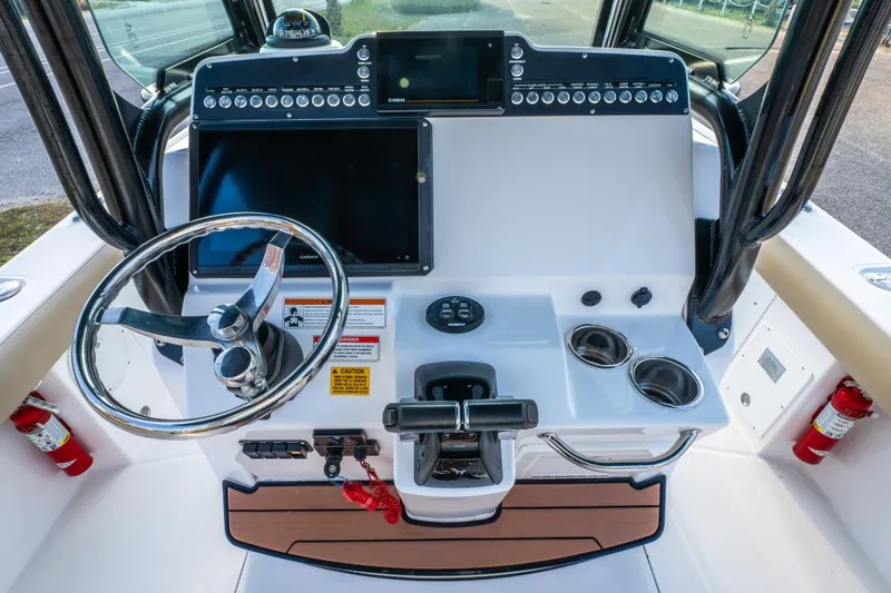 Slide: The Image of Control panel on a 2019 Everglades 273CC boat with switches and safety lanyard. - 42