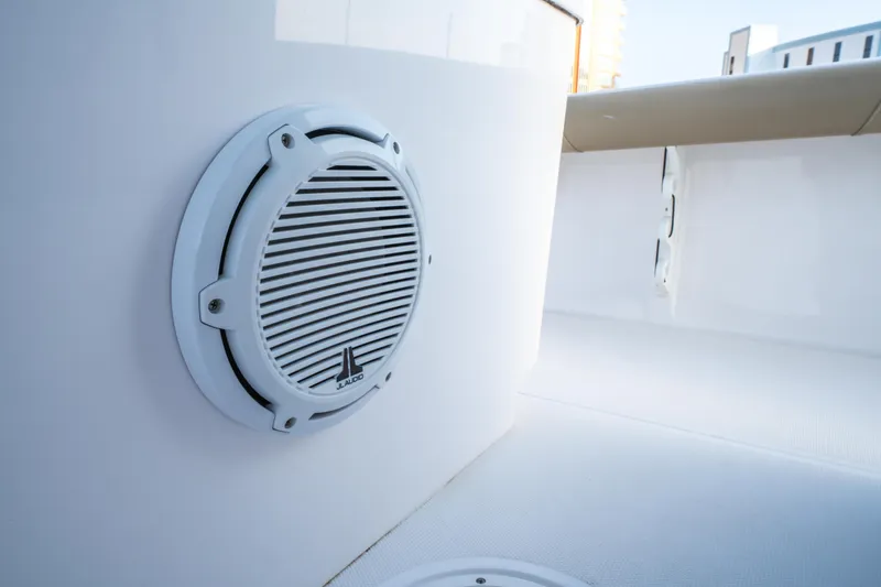 Slide: The Image of 2019 Everglades 273CC boat on trailer, parked outdoors with palm trees in background. - 50