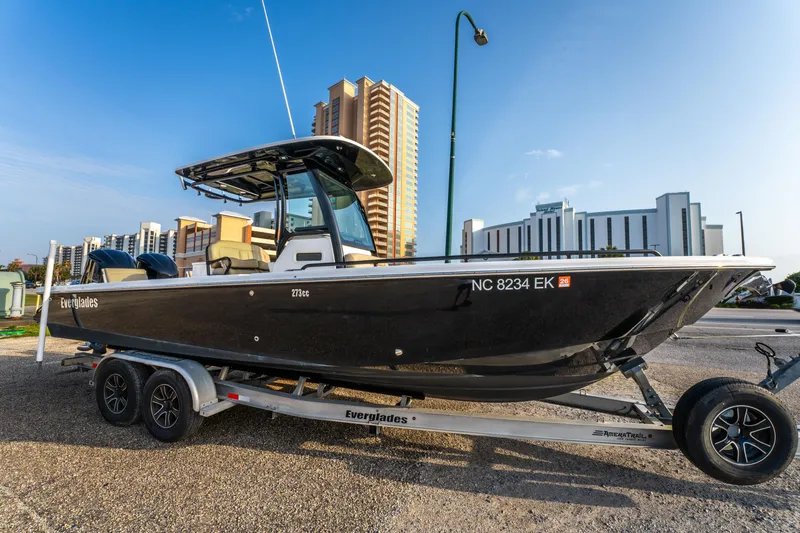 Slide: The Image of 2019 Everglades 273CC boat on trailer, urban background, clear sky. - 9