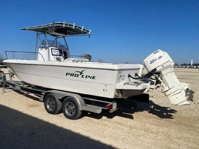 Slide: The Image of 1997 Pro-Line 240 Center Console boat on trailer with Johnson outboard motor. - 3