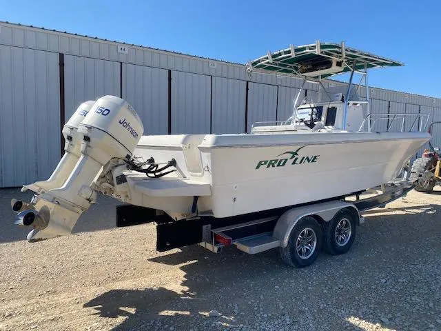 Slide: The Image of 1997 Pro-Line 240 Center Console boat with Johnson 150 outboard motor on trailer. - 5