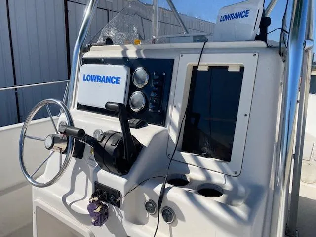 Slide: The Image of 1997 Pro-Line 240 Center Console boat dashboard with Lowrance navigation equipment. - 6